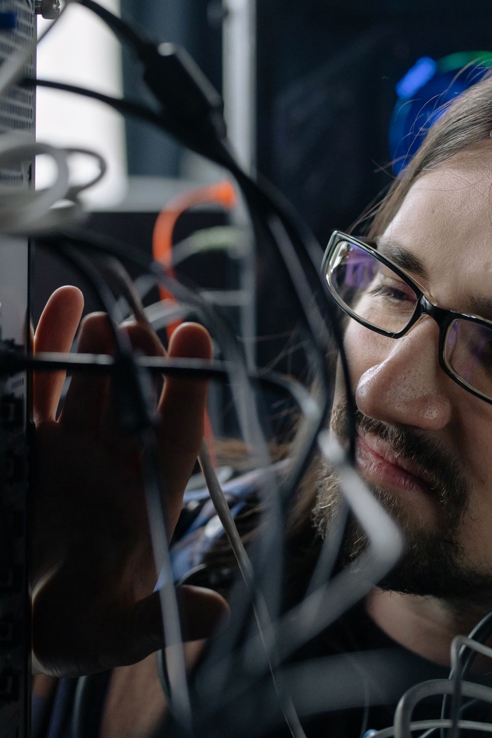 Technician working with cabling at a server rack